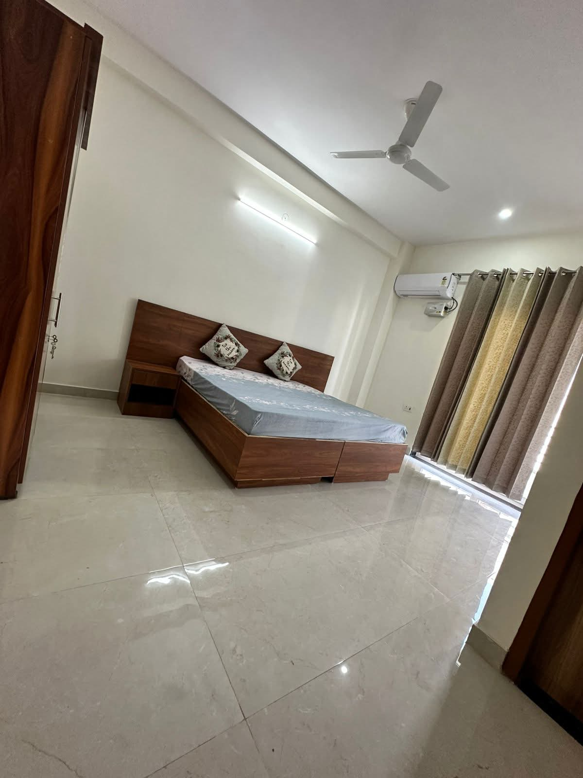 Furnished bedroom with AC and curtains