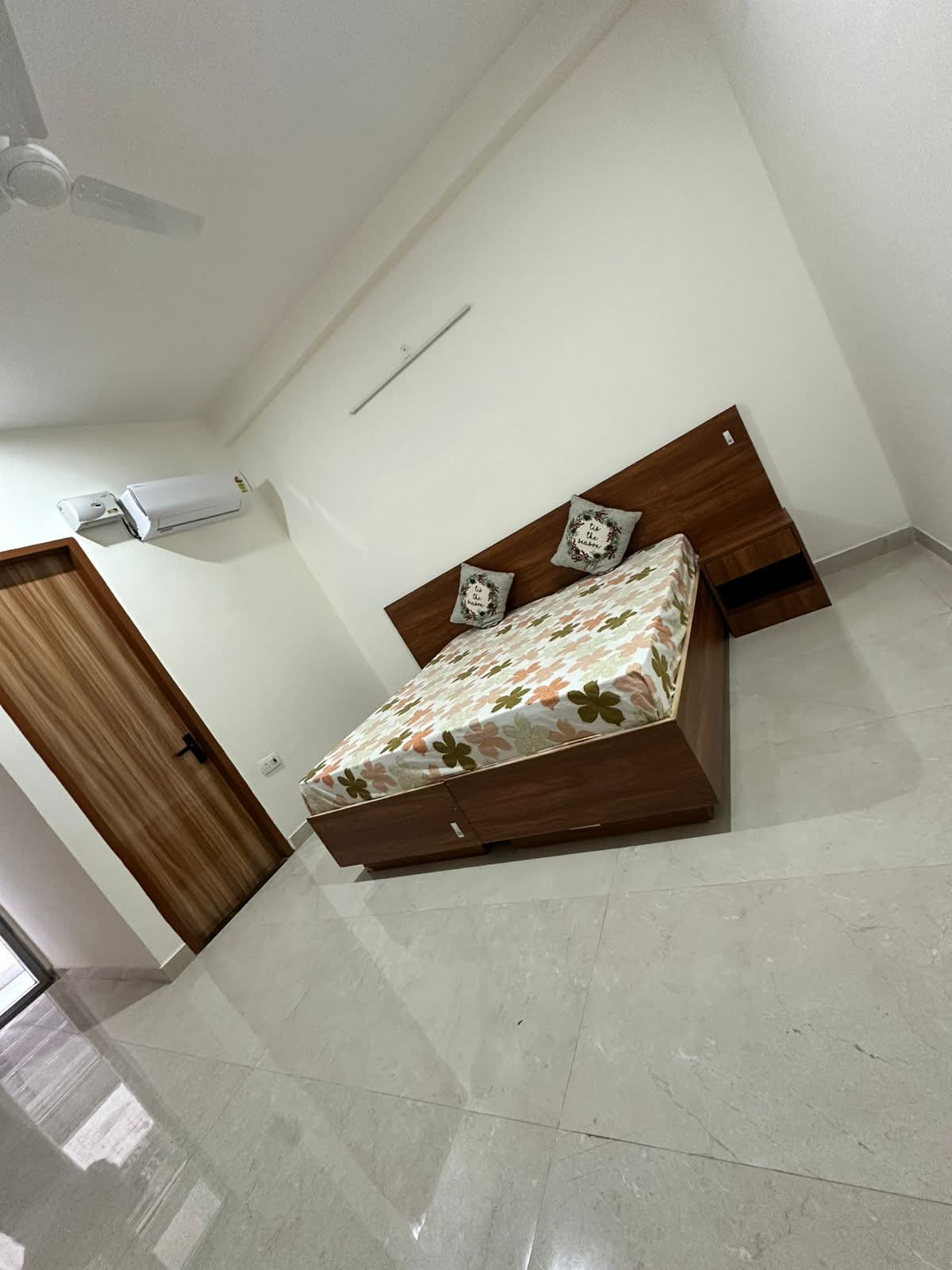 Bedroom with wooden furniture and AC